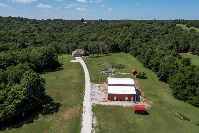 birds eye view of property featuring a wooded view