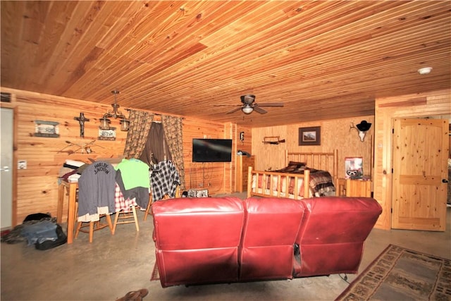 home theater with concrete flooring, wood ceiling, wood walls, and a ceiling fan