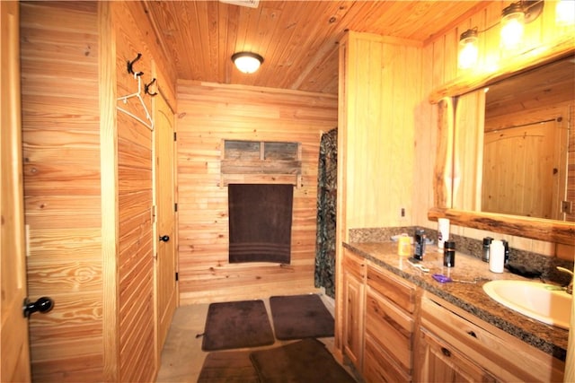 full bath with wooden ceiling, vanity, and wood walls