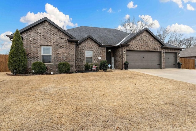 single story home with a garage, driveway, brick siding, and a front yard