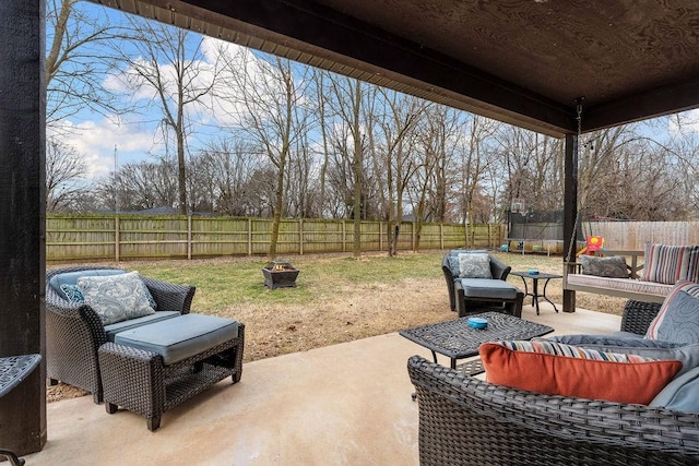 view of patio featuring a trampoline, outdoor lounge area, and a fenced backyard