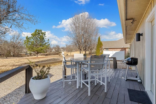 wooden deck featuring outdoor dining space