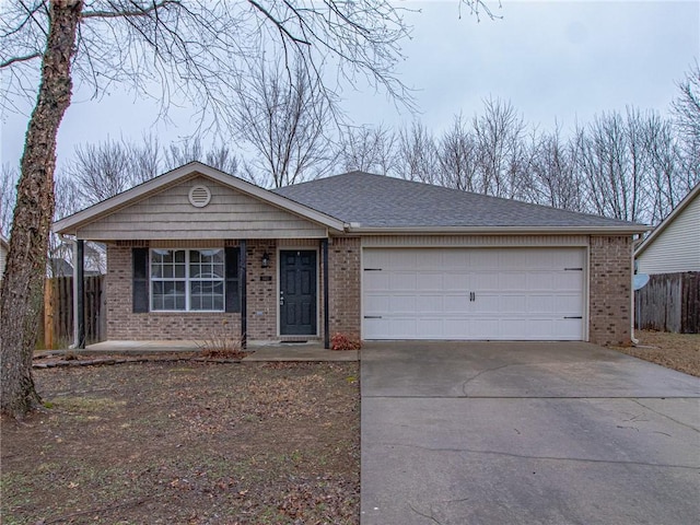 ranch-style home featuring driveway, a garage, a shingled roof, fence, and brick siding