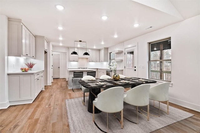 dining area featuring light wood-type flooring, visible vents, baseboards, and recessed lighting