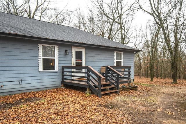 exterior space with roof with shingles