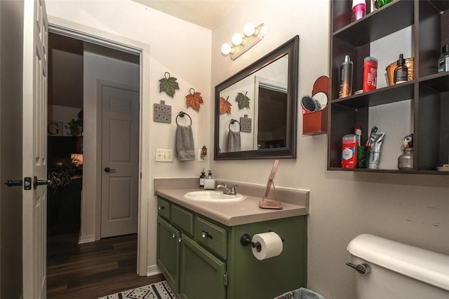 bathroom featuring vanity, toilet, and wood finished floors