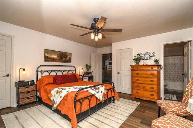 bedroom with dark wood-style floors, ceiling fan, and ensuite bathroom