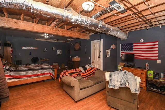 bedroom featuring visible vents and wood finished floors