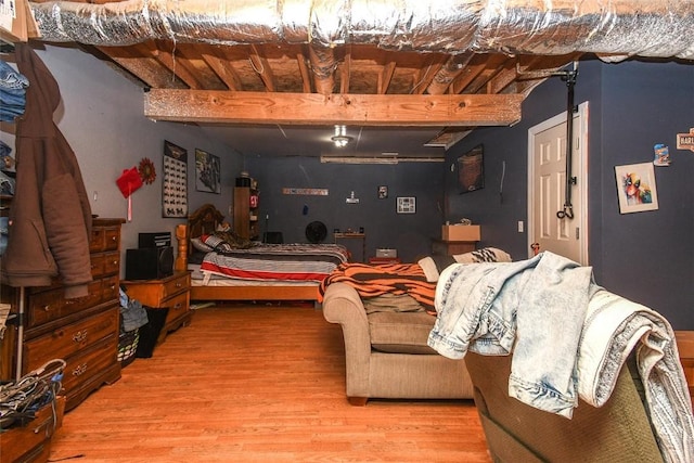 interior space featuring beamed ceiling and wood finished floors