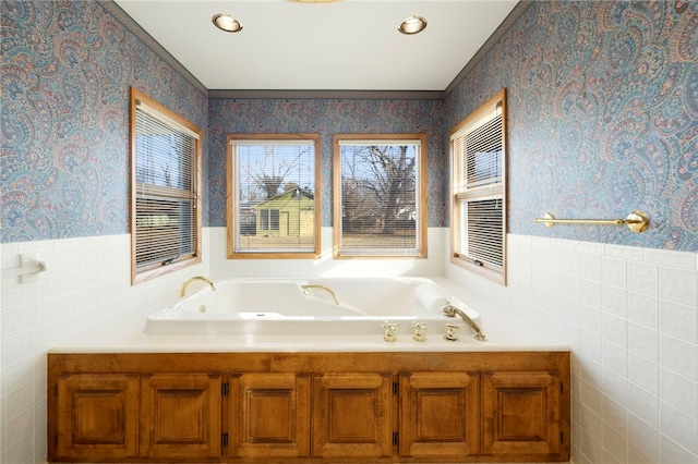 bathroom featuring a garden tub, recessed lighting, a wainscoted wall, tile walls, and wallpapered walls