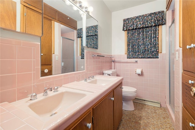 full bathroom featuring a baseboard heating unit, tile walls, a sink, and a shower stall