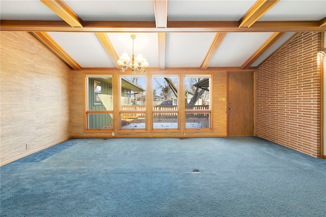 unfurnished room with vaulted ceiling with beams, brick wall, carpet flooring, and a chandelier