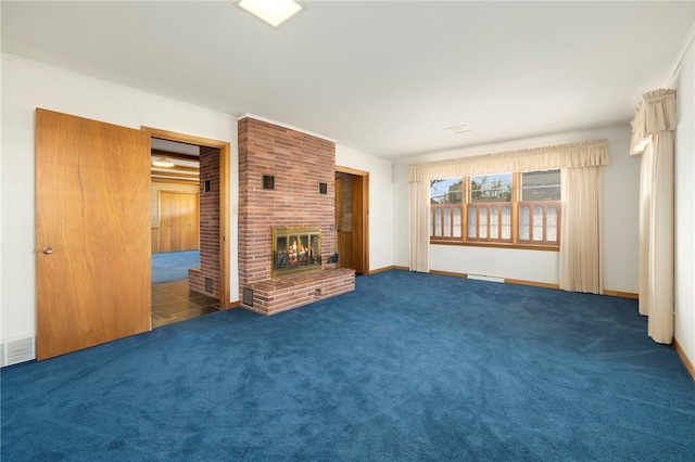 unfurnished living room featuring baseboards, ornamental molding, dark carpet, a fireplace, and a baseboard heating unit