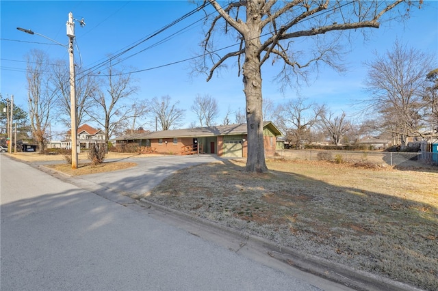 view of front of property with aphalt driveway and fence