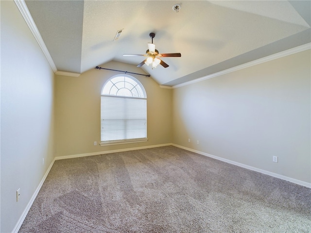 carpeted spare room with baseboards, visible vents, a ceiling fan, ornamental molding, and vaulted ceiling