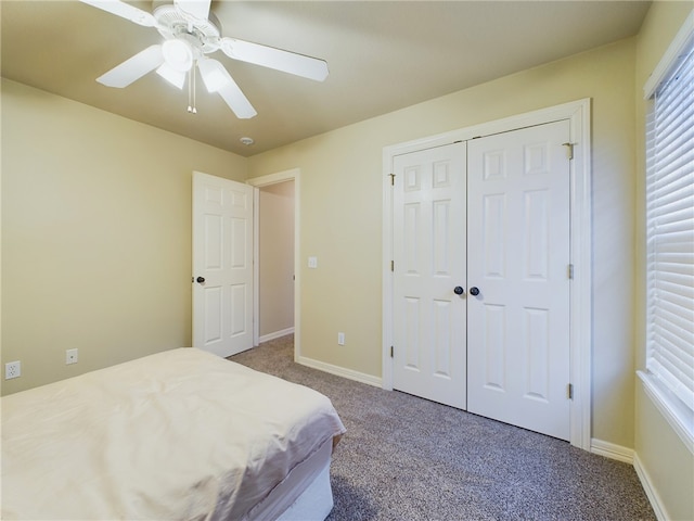 bedroom with carpet floors, a closet, baseboards, and a ceiling fan