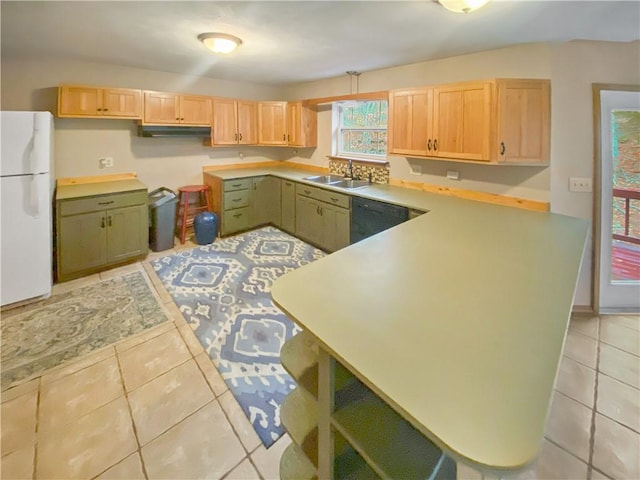 kitchen featuring light tile patterned floors, a sink, light countertops, freestanding refrigerator, and dishwasher