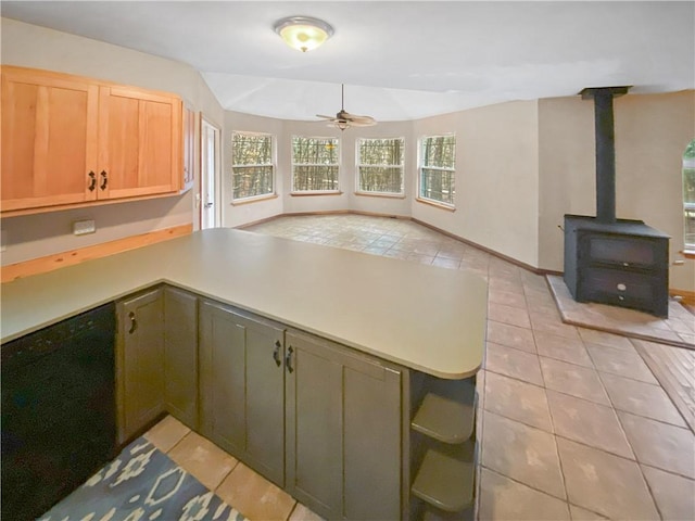 kitchen with dishwasher, light countertops, a peninsula, and light tile patterned flooring