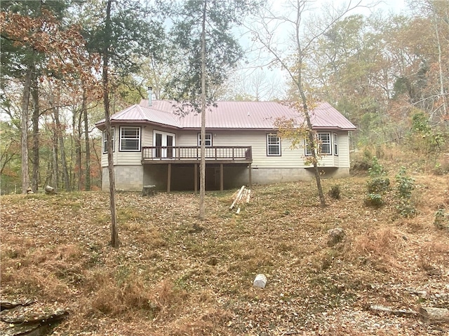 rear view of house with a deck and metal roof