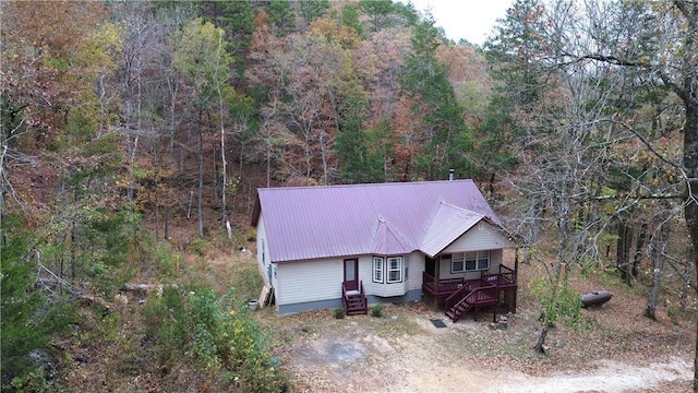 drone / aerial view featuring a forest view