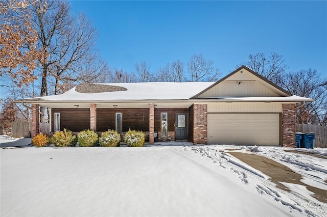 view of front of property featuring an attached garage and brick siding