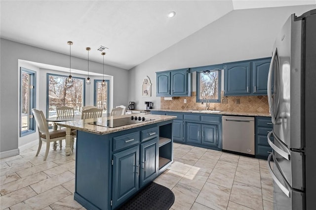 kitchen with appliances with stainless steel finishes, a center island, blue cabinets, pendant lighting, and a sink