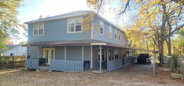 exterior space with a porch and fence