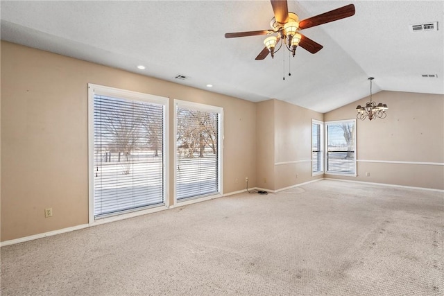 carpeted empty room featuring lofted ceiling, visible vents, and baseboards