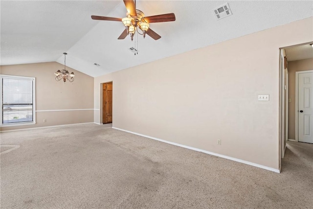 unfurnished room featuring lofted ceiling, baseboards, visible vents, and light colored carpet