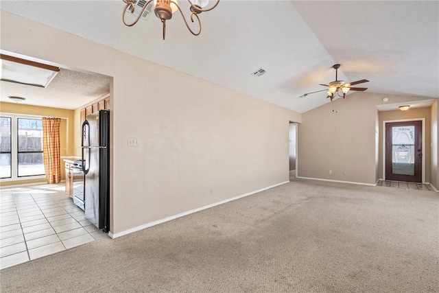 empty room with light carpet, baseboards, visible vents, and lofted ceiling