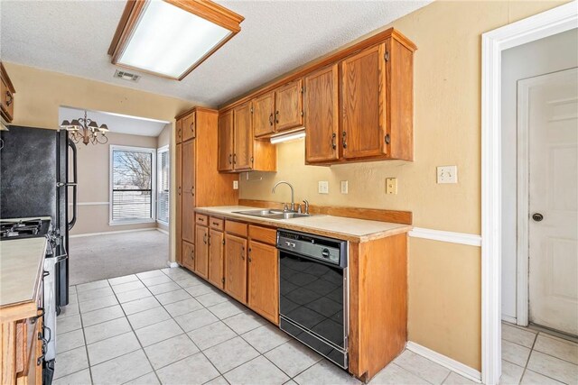 kitchen featuring light countertops, dishwasher, visible vents, and a sink