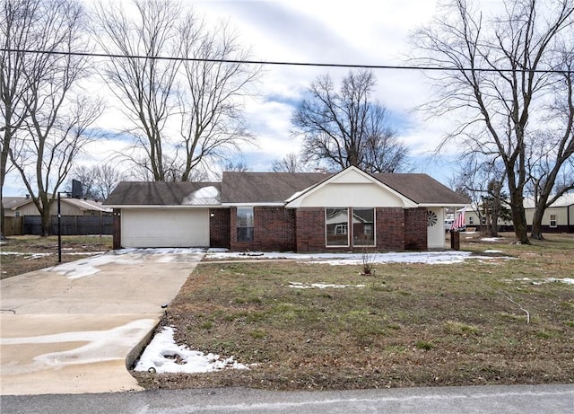 view of front of house featuring driveway, brick siding, and an attached garage