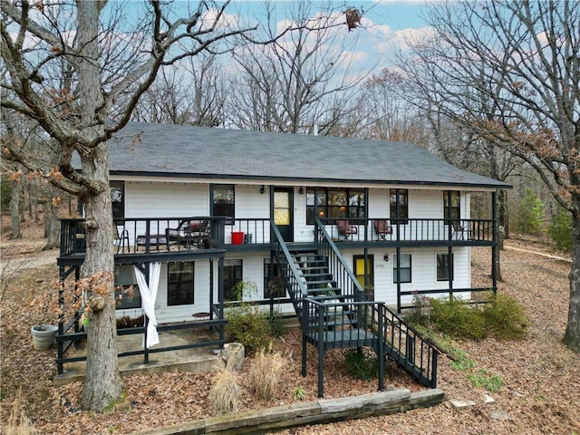 view of front facade featuring stairway and a balcony