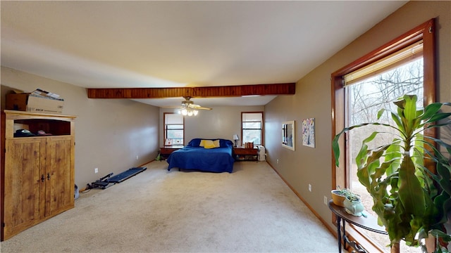 bedroom with baseboards, a ceiling fan, and light colored carpet