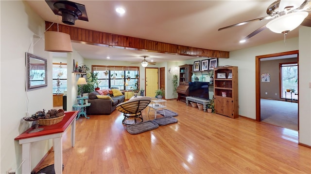 living area featuring baseboards, a ceiling fan, wood finished floors, and recessed lighting