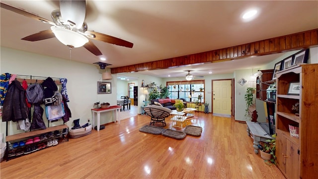 living room with a ceiling fan and light wood-style flooring