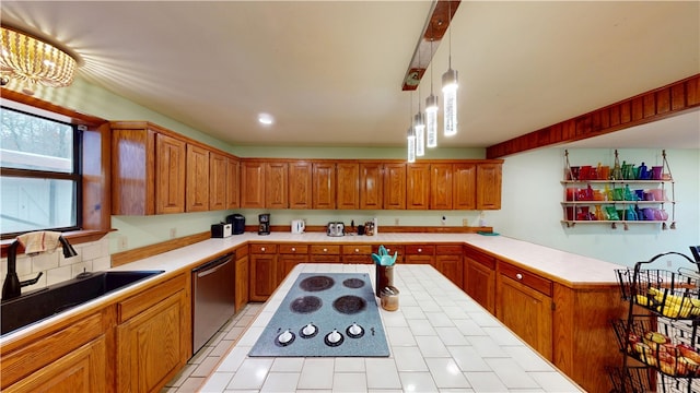 kitchen with brown cabinetry, pendant lighting, light countertops, and stainless steel dishwasher