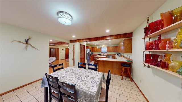 dining room featuring light tile patterned floors, baseboards, and recessed lighting