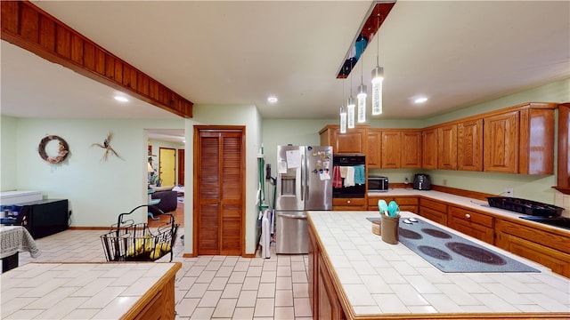 kitchen with oven, stainless steel fridge, tile counters, and white electric cooktop