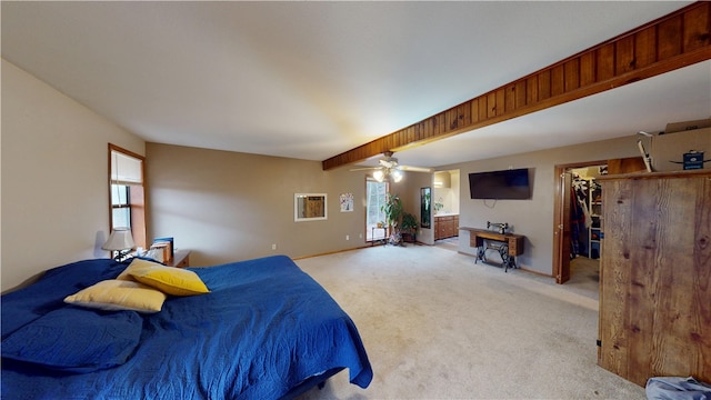 bedroom with light colored carpet, ceiling fan, a spacious closet, and baseboards