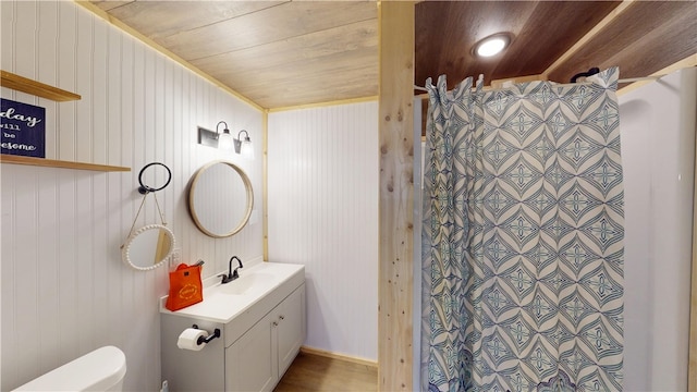 bathroom with toilet, wood ceiling, walk in shower, and vanity