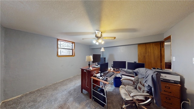 office area with dark carpet, a textured ceiling, and ceiling fan