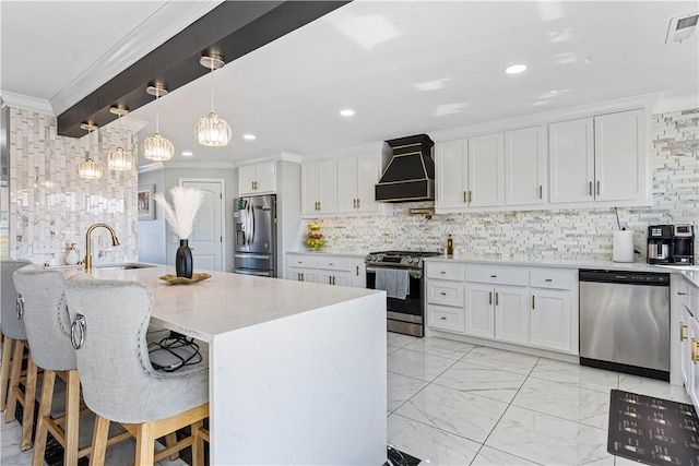 kitchen featuring premium range hood, a breakfast bar, white cabinets, light countertops, and appliances with stainless steel finishes