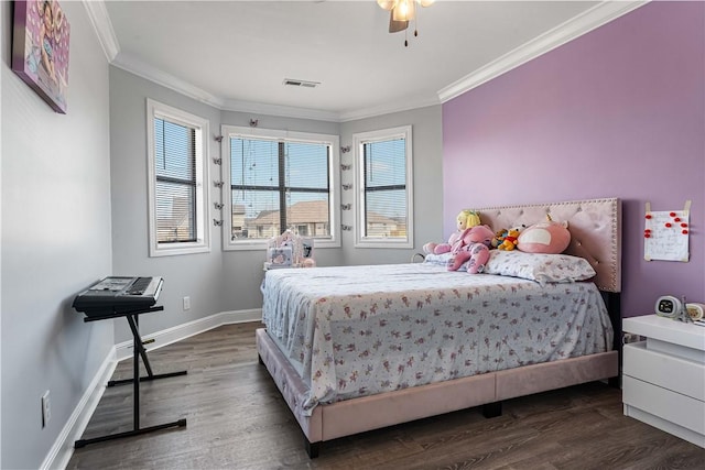 bedroom featuring baseboards, crown molding, visible vents, and wood finished floors
