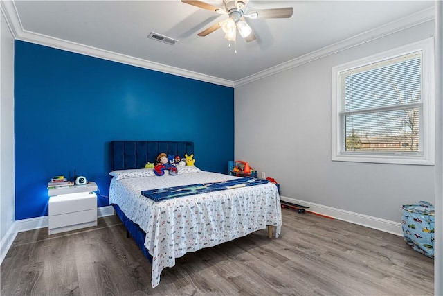 bedroom with ceiling fan, baseboards, crown molding, and wood finished floors