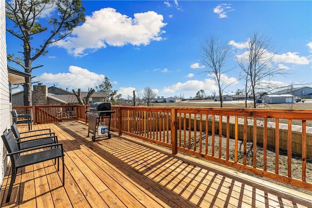 wooden deck with a residential view and grilling area