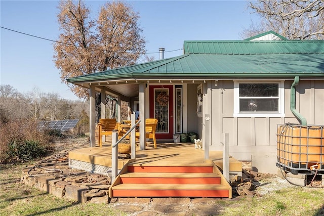 exterior space with board and batten siding and metal roof