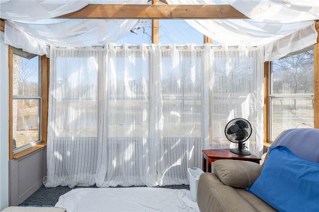 sunroom / solarium featuring beamed ceiling