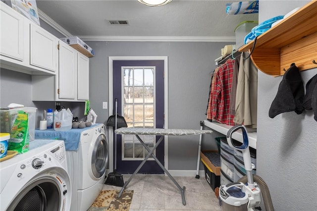 laundry room with visible vents, ornamental molding, cabinet space, and washer and dryer