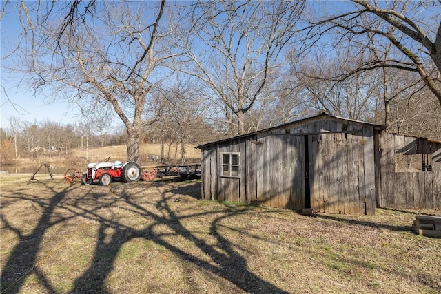 view of outbuilding featuring dirt driveway and an outdoor structure